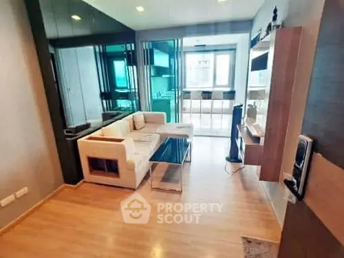 Modern living room with sleek design and open layout, featuring a cozy sofa and stylish decor.