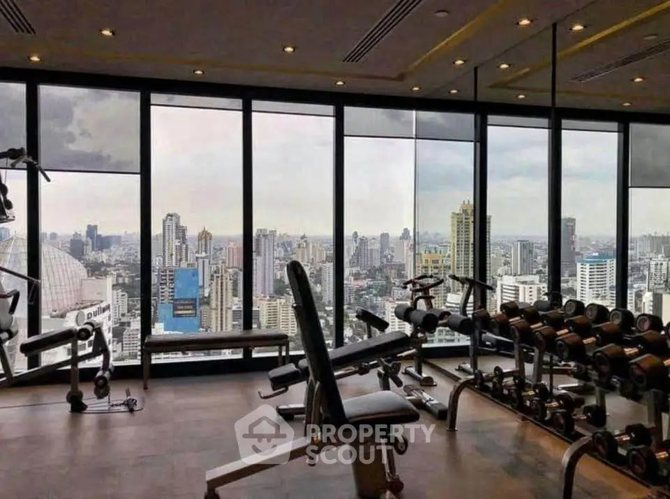 Luxurious gym with panoramic city view and modern equipment.