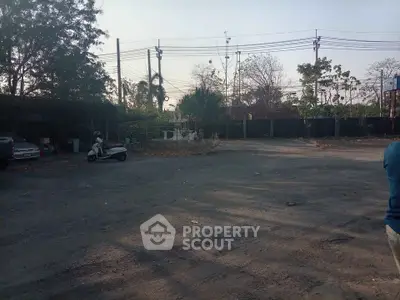 Spacious outdoor area with potential for development, featuring open space and surrounding greenery.