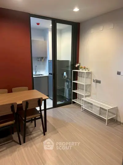 Modern dining area with adjacent compact kitchen in a stylish apartment