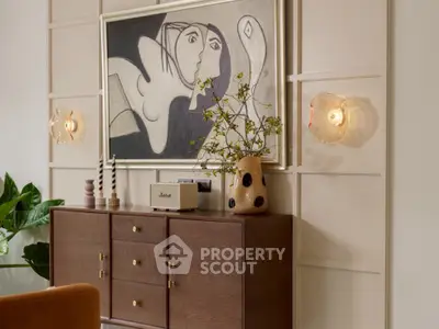 Stylish living room with modern art and elegant wooden sideboard.