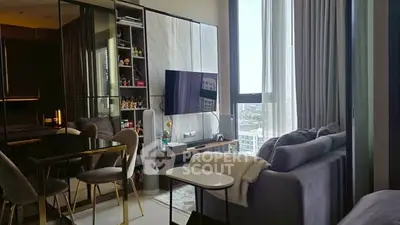 Modern living room with large windows and stylish decor in a high-rise apartment.