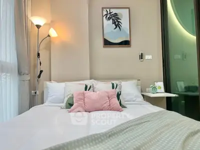 Cozy bedroom with stylish decor and soft lighting, perfect for relaxation.