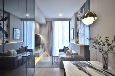 Modern living room with elegant decor and large windows for natural light.