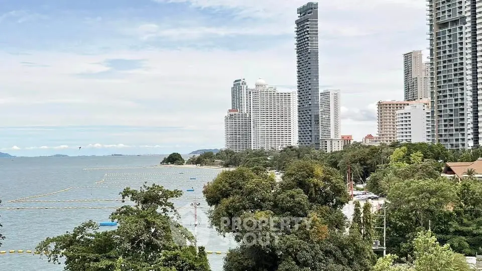 Stunning coastal view with modern high-rise buildings and lush greenery, perfect for luxury living.