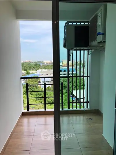 Spacious balcony with scenic view and air conditioning unit in modern apartment.