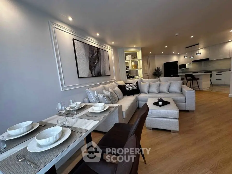 Spacious modern living room with elegant dining area and open kitchen layout.