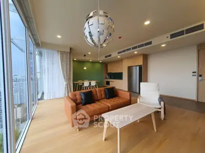 Modern open-layout living room with city view, featuring stylish furniture and floor-to-ceiling windows.