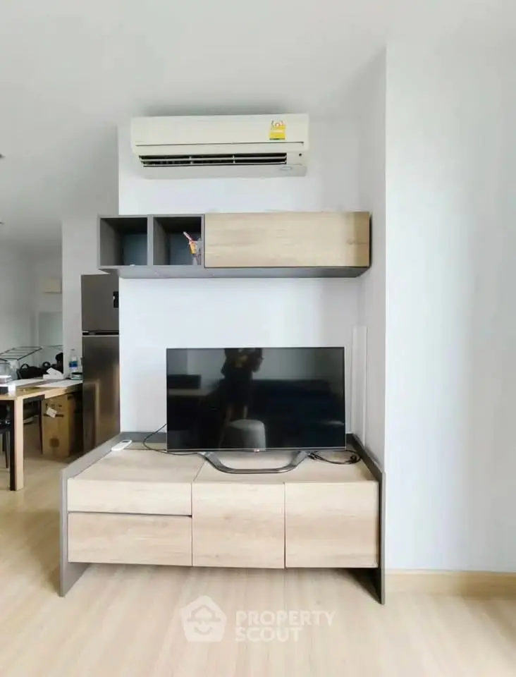 Modern living room with sleek TV stand and air conditioning unit