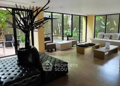 Spacious modern living room with large windows and garden view