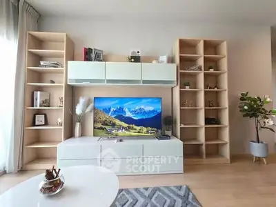 Modern living room with stylish shelving and large TV, perfect for relaxation and entertainment.