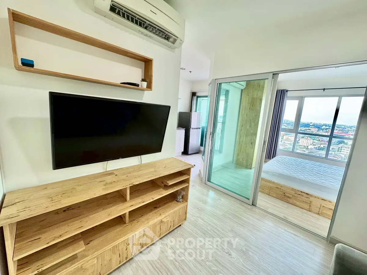 Modern apartment interior with wooden furniture and city view from bedroom