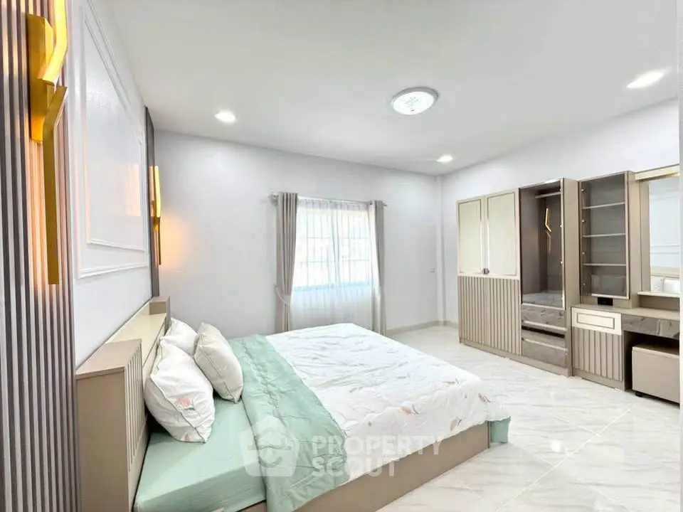 Spacious modern bedroom with elegant furnishings and natural light