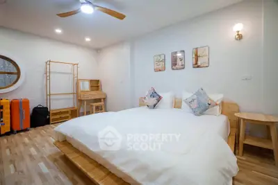 Spacious modern bedroom with stylish decor and wooden flooring