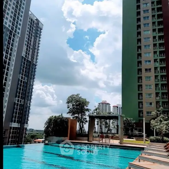 Luxurious residential complex with stunning pool and cityscape view.