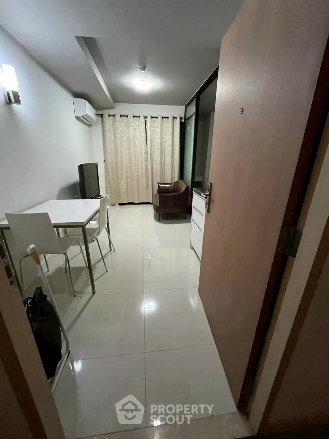 Modern living room with sleek furniture and large window for natural light.