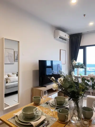 Modern living room with dining area, stylish decor, and large window view