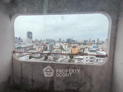 Stunning cityscape view from a high-rise building window, showcasing urban skyline and vibrant architecture.