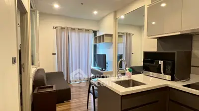 Modern compact living space with integrated kitchen and cozy seating area.