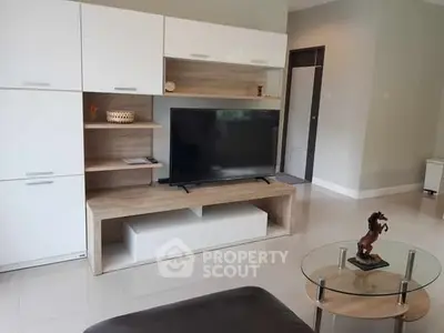 Modern living room with sleek TV unit and glass coffee table