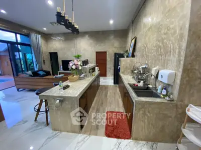 Luxurious open-layout kitchen with marble countertops and modern appliances