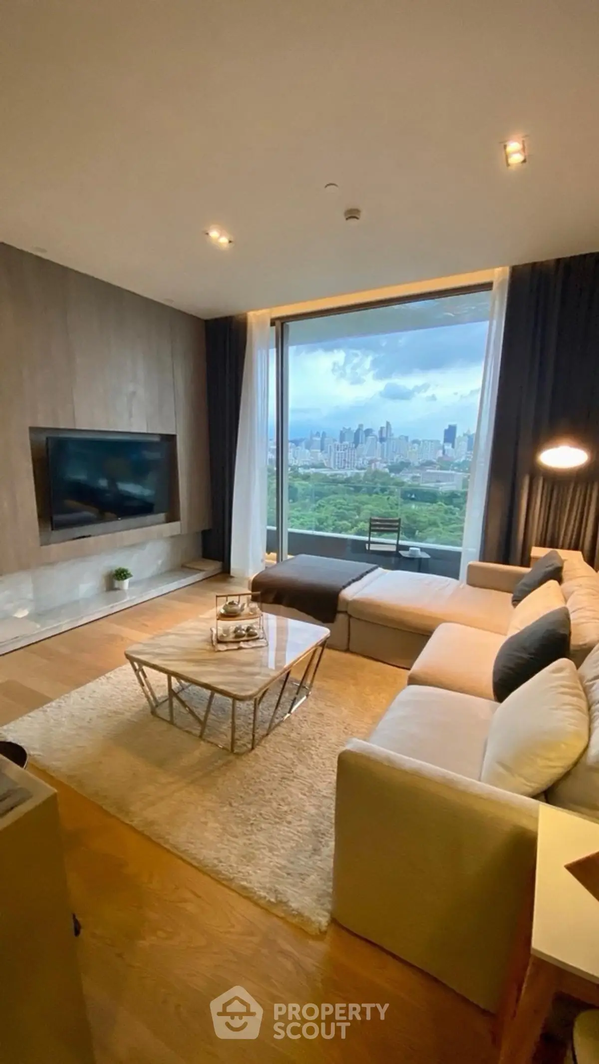 Luxurious living room with stunning city view, modern furniture, and elegant decor.