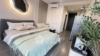 Modern bedroom with stylish decor and cozy ambiance, featuring a comfortable bed and elegant furnishings.