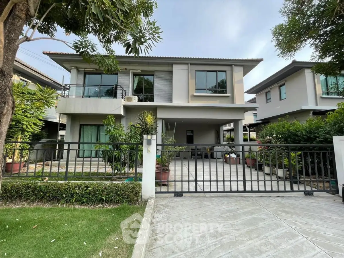 Modern two-story house with lush garden and spacious driveway