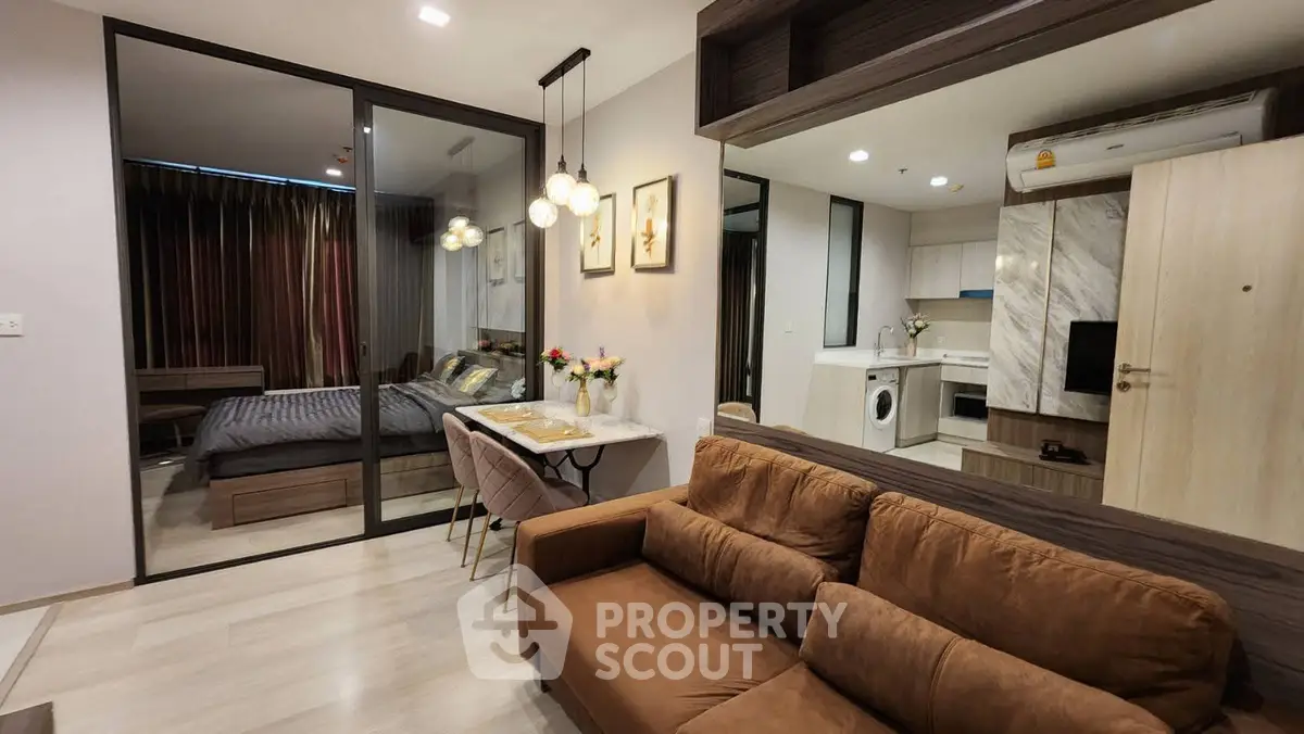 Modern open-plan living room with cozy brown sofa and stylish kitchen area