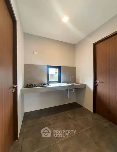 Modern minimalist kitchen with sleek countertops and gas stove