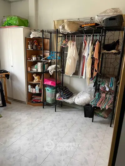 Cozy storage room with organized shelves and clothing racks