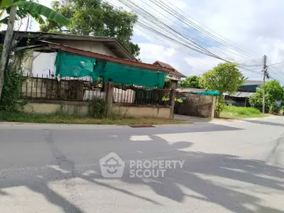 Charming suburban house with lush greenery and street view, perfect for tranquil living.