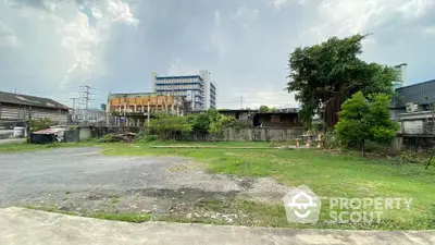 Spacious vacant land with urban backdrop ideal for development opportunities.