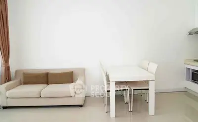Modern living room with beige sofa and dining area in open layout