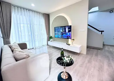 Modern living room with stylish decor and wall-mounted TV