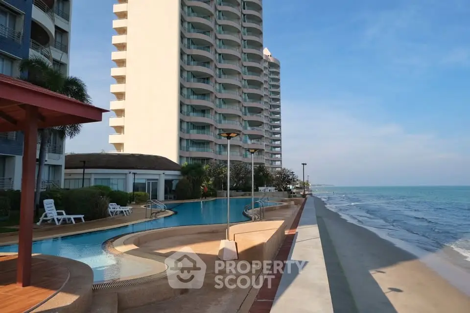 Stunning beachfront condominium with pool and ocean view, perfect for luxury living.