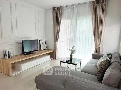 Modern living room with sleek furniture and large window for natural light.