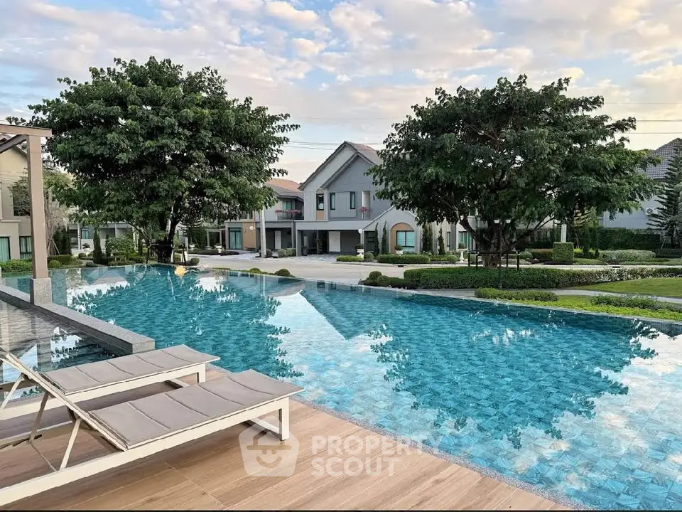 Luxurious residential pool area with serene surroundings and modern architecture.