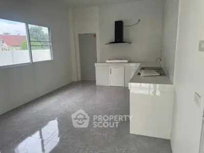 Spacious modern kitchen with sleek countertops and ample natural light