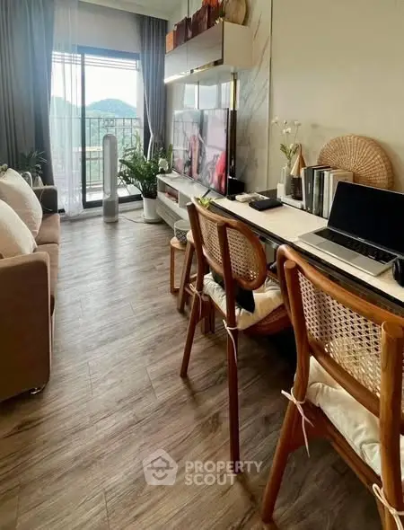 Modern living room with balcony view, stylish furniture, and natural light.