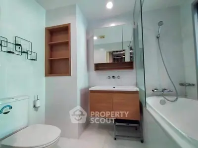 Modern bathroom with sleek fixtures and bathtub in a stylish apartment.