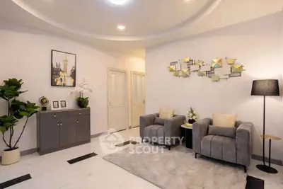 Elegant living room with modern decor, plush seating, and stylish wall art in a cozy setting.