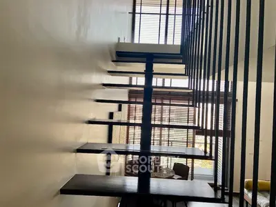 Modern floating staircase with sleek design and natural light, perfect for contemporary homes.