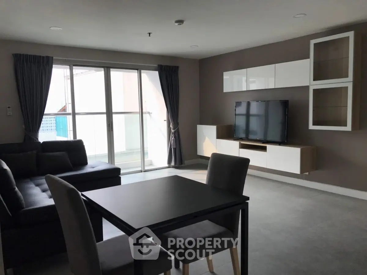 Modern living room with sleek furniture and large window for natural light.