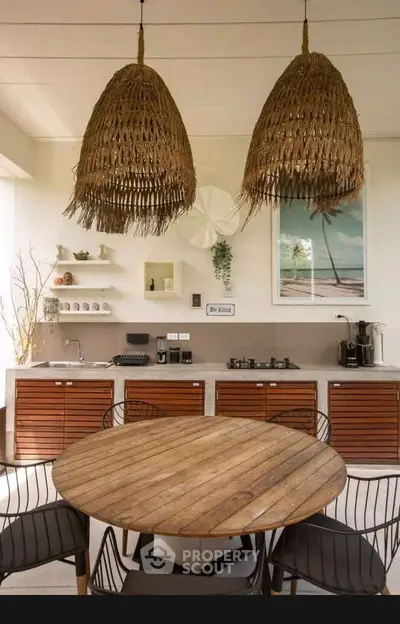 Chic kitchen with open layout, wicker pendant lights, and modern appliances.