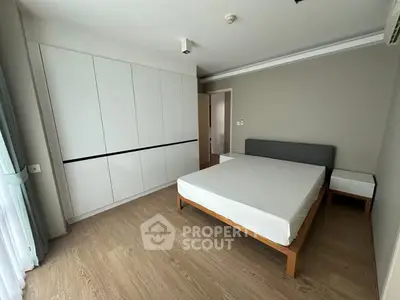 Spacious modern bedroom with minimalist design and ample storage space.
