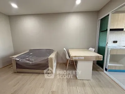 Modern minimalist living space with compact dining area and kitchen