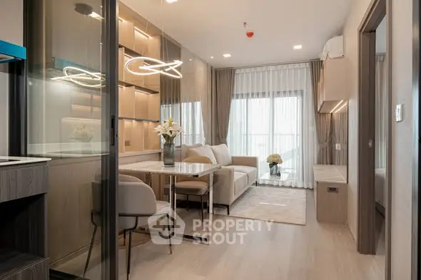 Modern living room with elegant dining area and stylish lighting in a contemporary apartment.