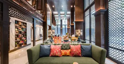 Luxurious living room with elegant decor and large windows in a high-end property.
