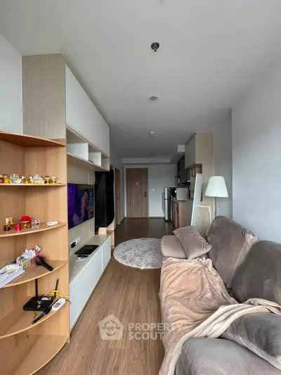 Modern living room with cozy sofa and stylish shelving in a contemporary apartment.